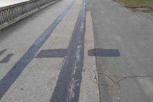 The lines of the cycling path painted out in black.