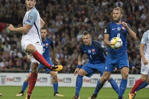 England's Eric Dier, left, scores his first goal.