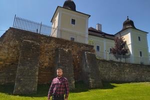 Historian Ondrej Glod in front of the early Gothic church featuring Byzantine elements.