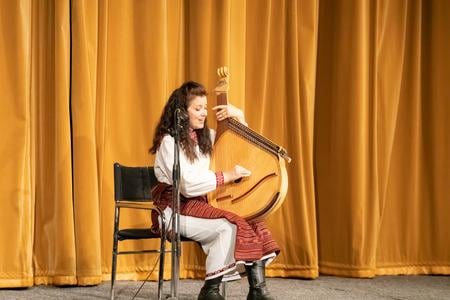 Olga Smorkis playing the bandura during a concert in DK Ružinov, Bratislava, on December 22, 2023.