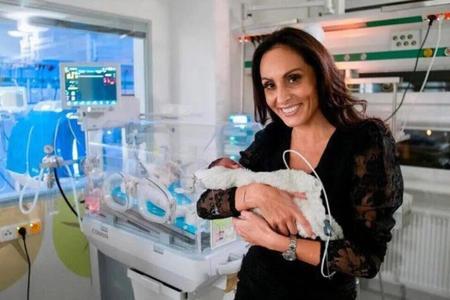 Health Minister Zuzana Dolinková poses with a premature baby.