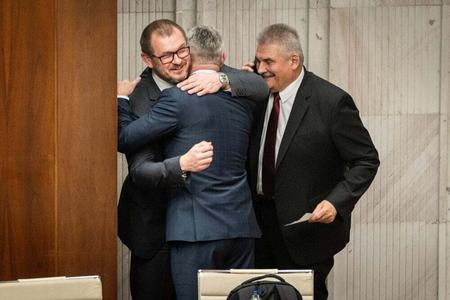 Tibor Gaspar (center) celebrates the passing of the law with fellow Smer MPs. 