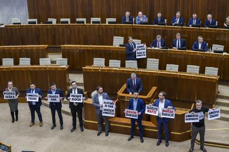 Opposition MPs with posters in the debating chamber in Bratislava on February 8, 2024.