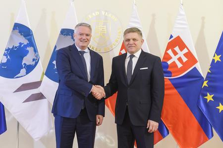 OECD Secretary-General Mathias Cormann (left) and PM Robert Fico (right).