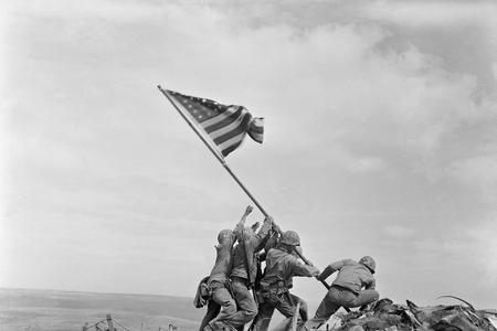 The iconic WW2 photograph taken in February 23, 1945 on Mount Suribachi. Michael Strank is barely visible between the second and third soldier from left. 