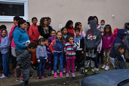 Parents and children wait outside the school building at the beginning of the new school year 2016-2017 in the Roma settlement in the village of Rakúsy, Kežmarok district, on September 5, 2016.