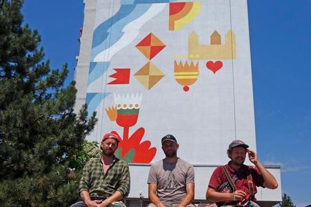 (From left) Viktor Feher, Martin Kleibl and Michal Turkovič, sitting under the renewed wall painting in Bratislava's Petržalka.