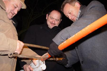 Slovak and Hungarian officials symbolically cutting the barrier between their countries after Slovakias's entry into the Schengen zone.