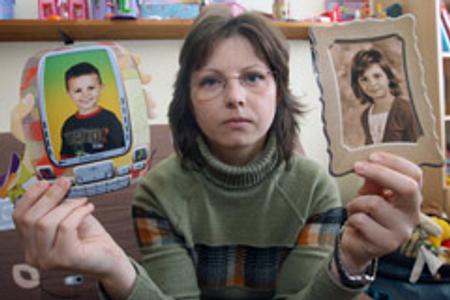 Daniela Hammoud shows pictures of her missing children, Husein and Fatima.