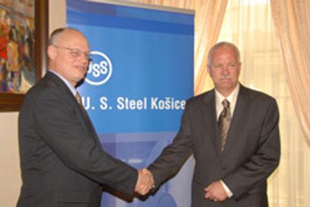 David H Lohr (left) greets his successor, George F Babcoke.