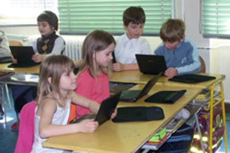 One school has replaced second-graders' paper notebooks with computers.