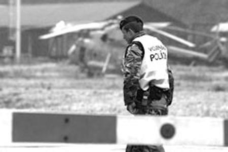 A military policeman looks on in Nováky after the 2007 explosion there.