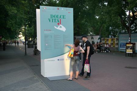 People looking at the Dolce Vitaj festival programme.