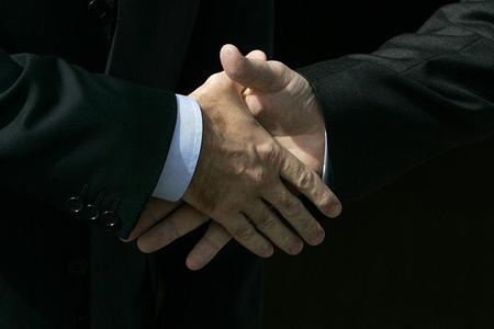The premiers greet each other.