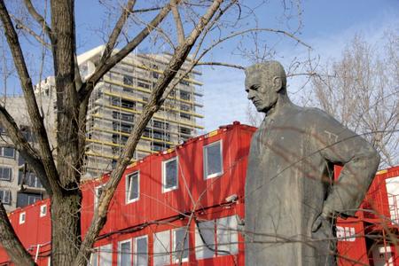 Celebrated Slovak architect Dušan Jurkovič looks on as another new building rises up next to him.
