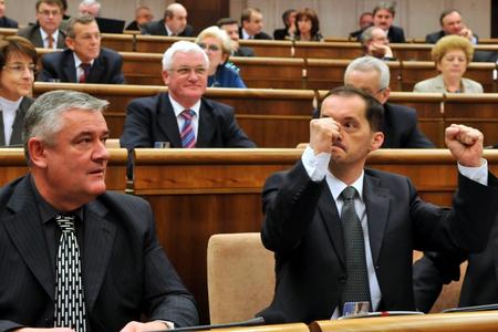 Ján Slota and Rafael Rafaj  react as their law is passed.