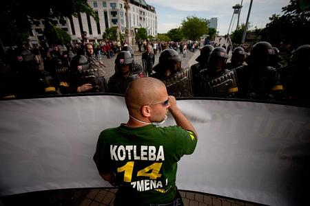A skinhead faces riot police in central Bratislava.