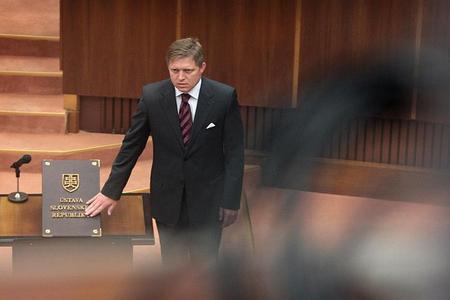 Robert Fico descends from the prime minister's seat back to parliament. 