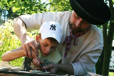 Igor Prilinský teaches children woodcarvng