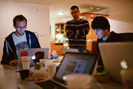 Screen burn: Young IT experts at work.