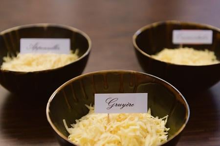 Three types of grated cheese for the fondue.