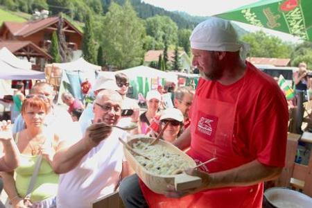 Halušky offered to visitors of a festival. 
