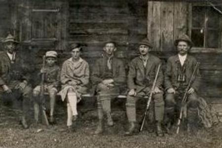 Hunters in front of a lodge