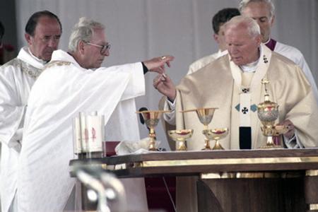 Korec (2L) aids Pope John Paul II during a holy mass in the Slovak town of Levoča. 