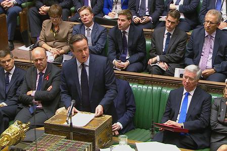 British Prime Minister David Cameron talks to lawmakers inside the House of Commons in London during a debate on launching airstrikes against Islamic State extremists inside Syria.
