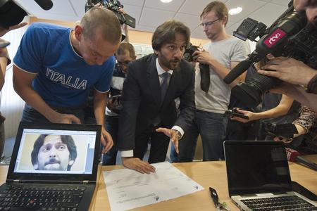 Minister Robert Kaliňák showing documents.