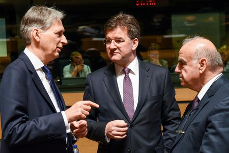 British Foreign Minister Philip Hammond, left, speaks with Slovakia's Foreign Minister Miroslav Lajčák, middle, and Malta's Foreign Minister George Vella during a meeting of EU foreign ministers at the EU Council building in Luxembourg, on June 20.