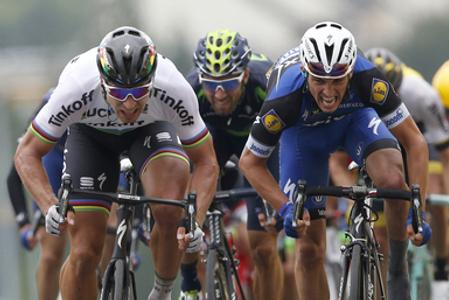 Peter Sagan of Slovakia (L) crosses the finish line ahead of France’s Julian Alaphilippe (R) and Spain's Alejandro Valverde to win the second stage of the Tour de France cycling race Sunday, July 3, 2016. 