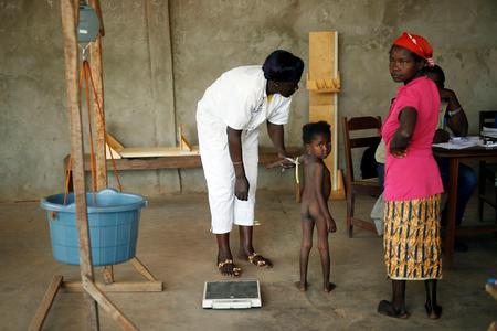 A child is weighed and measured by nurses in Bangui, Central African Republic.