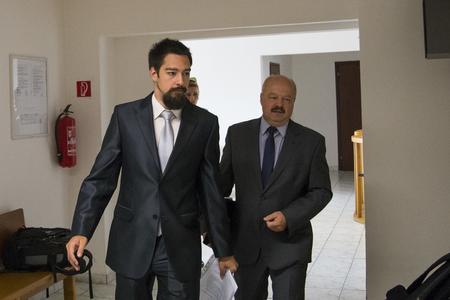 Accused man Martin M. with his father before the beginning of the trial