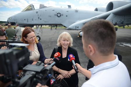 Kathie Baranski Lund answers the questions of journalists at a wreath-laying ceremony for Captain Baranski at Sliač Airfield.