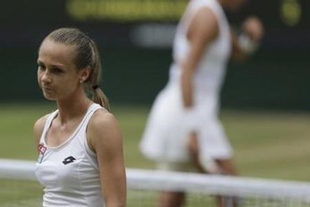 Slovakia's Magdalena Rybarikova walks away after losing a point to Spain's Garbine Muguruza during their Women's Singles semifinal match on day nine at the Wimbledon Tennis Championships.