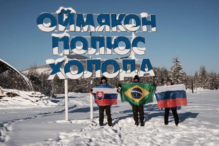 Dominik Bari and his colleges in front of inscription "Oymyakon, Pole of Cold"