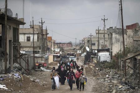 Iraqi civilians flee their homes during fighting between Iraqi security forces and Islamic State militants, on the western side of Mosul, Iraq, in March 2017.