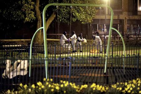 Investigators in protective suits work at the scene near the Maltings shopping centre in Salisbury, England, on Tuesday, March 13.
