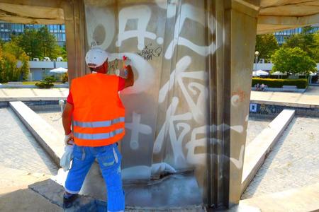 Cleaning the fountain at Námestie Slobody square of illegal graffiti.