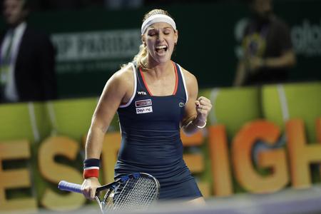 Dominika Cibulková celebrates winning ball during the match against Simona Halep at the 2016 WTA Tour world championship in Singapore.