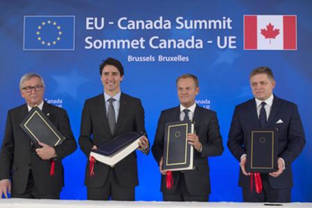 CETA singing, L-R:President of the European Commission Jean-Claude Juncker, Canadian Prime Minister Justin Trudeau, President of the European Council Donald Tusk, and Slovak Prime Minister Robert Fico, October 30, 2016