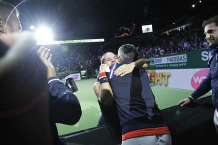Dominika Cibulková hugs her fitness coach and physio, Jozef Ivanka, with her coach Matej Lipták right and her husband, Michal Navara, left, after her victory at the WTA championship in Singapore, October 30 