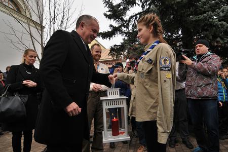President Andrej Kiska taking over light from Bethlehem from Slovak scouts.