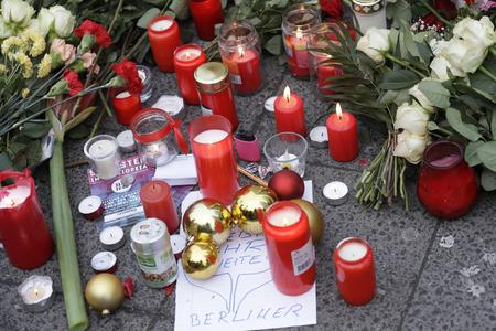 Candles burn near the crime scene in Berlin, Germany.