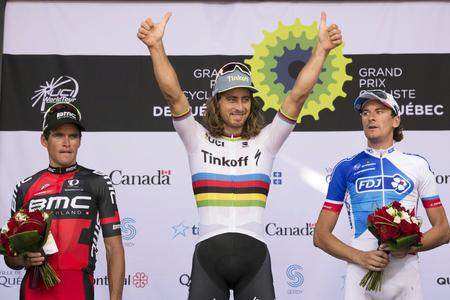 Peter Sagan, center, of Slovakia, raises his hands as he celebrates his win at the UCI Pro Tour cycling Grand Prix in Quebec City in September 2016.