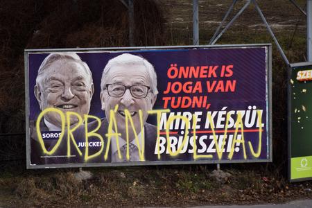 A billboard from a campaign of the Hungarian government showing European Commission President Jean-Claude Juncker and Hungarian-American financier George Soros with the caption "You, too, have a right to know what Brussels is preparing to do." is displayed at a street in Budapest.