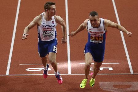 Britain's Richard Kilty (r) crosses the finish line to win the the men's 60-meter final ahead of second place Slovakia's Jan Volko (l).