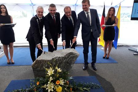 Kežmarok Mayor Ján Ferenčák, PM Peter Pellegrini, Mubea owner Thomas Muhr and Economy Minister Peter Žiga, from left, tapping the foundation stone of the brand new Mubea plant in Kežmarok Industrial Park.  