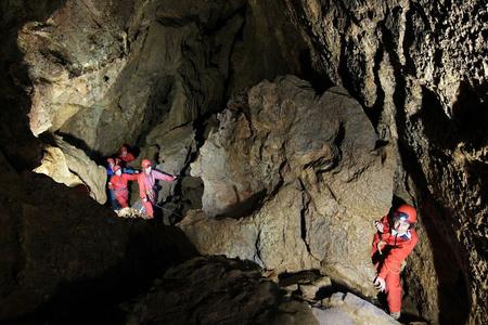 Visitors to Krásnohorská Cave get spelunking outfits for the full experience. 